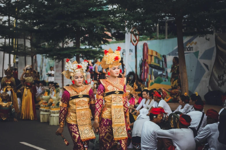 a group of people walking down a street, pexels contest winner, sumatraism, elaborately costumed, background image, twins, square