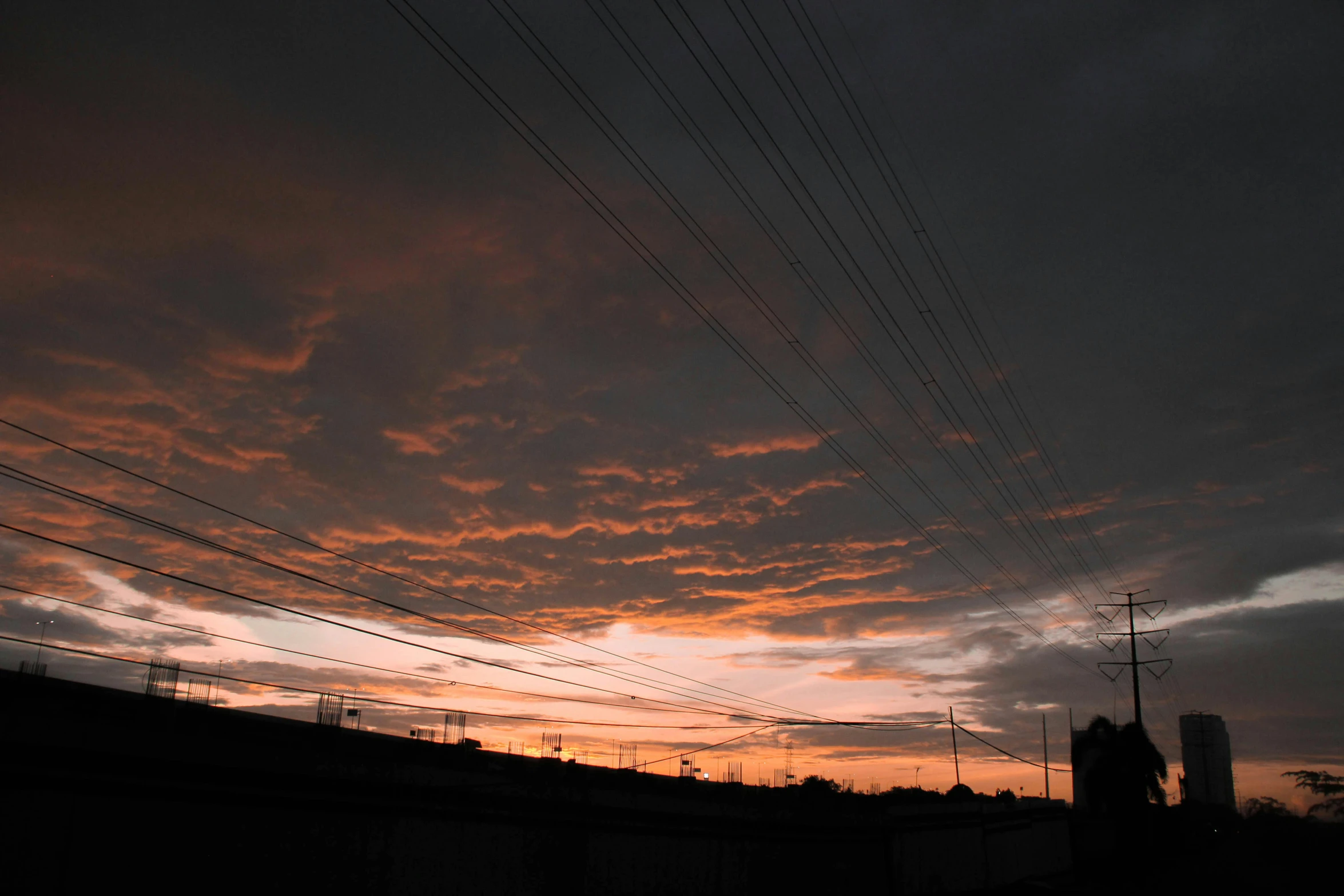 a sunset in the distance with power lines in the foreground, a picture, by Thomas Furlong, black clouds, low quality photo, anime sky, ((sunset))