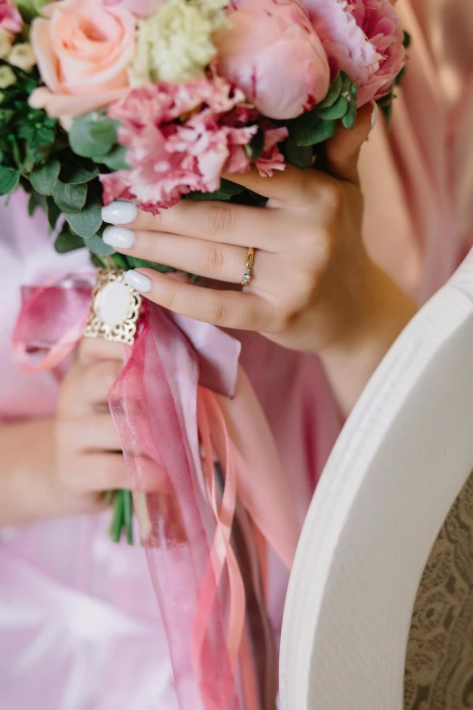 a close up of a person holding a bouquet of flowers, jewlery, pastel pink robes, art nouveau accents, pink accents