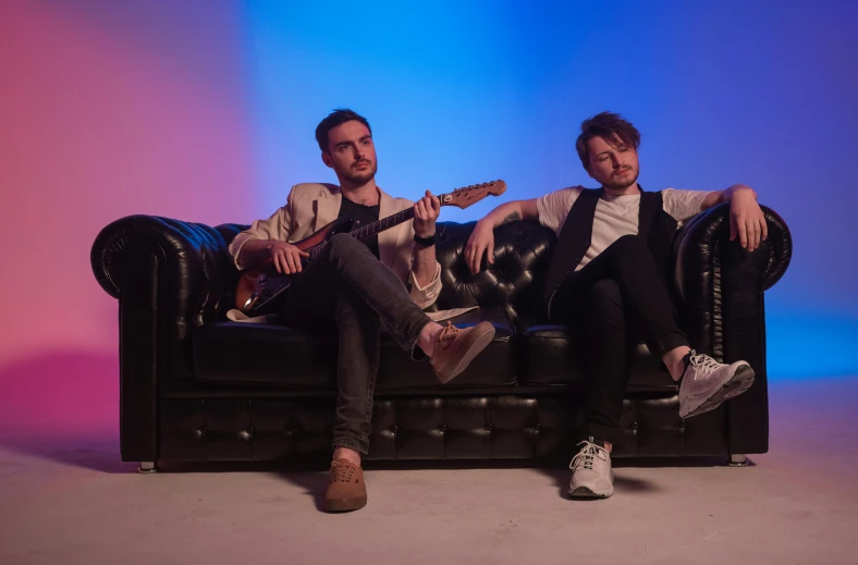two men sitting on a couch with guitars, pexels contest winner, private press, bisexual lighting, avatar image, in front of white back drop, liam
