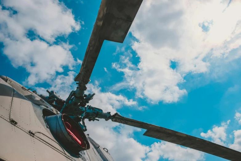 a close up of a helicopter with a sky background, by Adam Marczyński, pexels contest winner, hurufiyya, view from ground level, avatar image, maintenance photo, wide high angle view