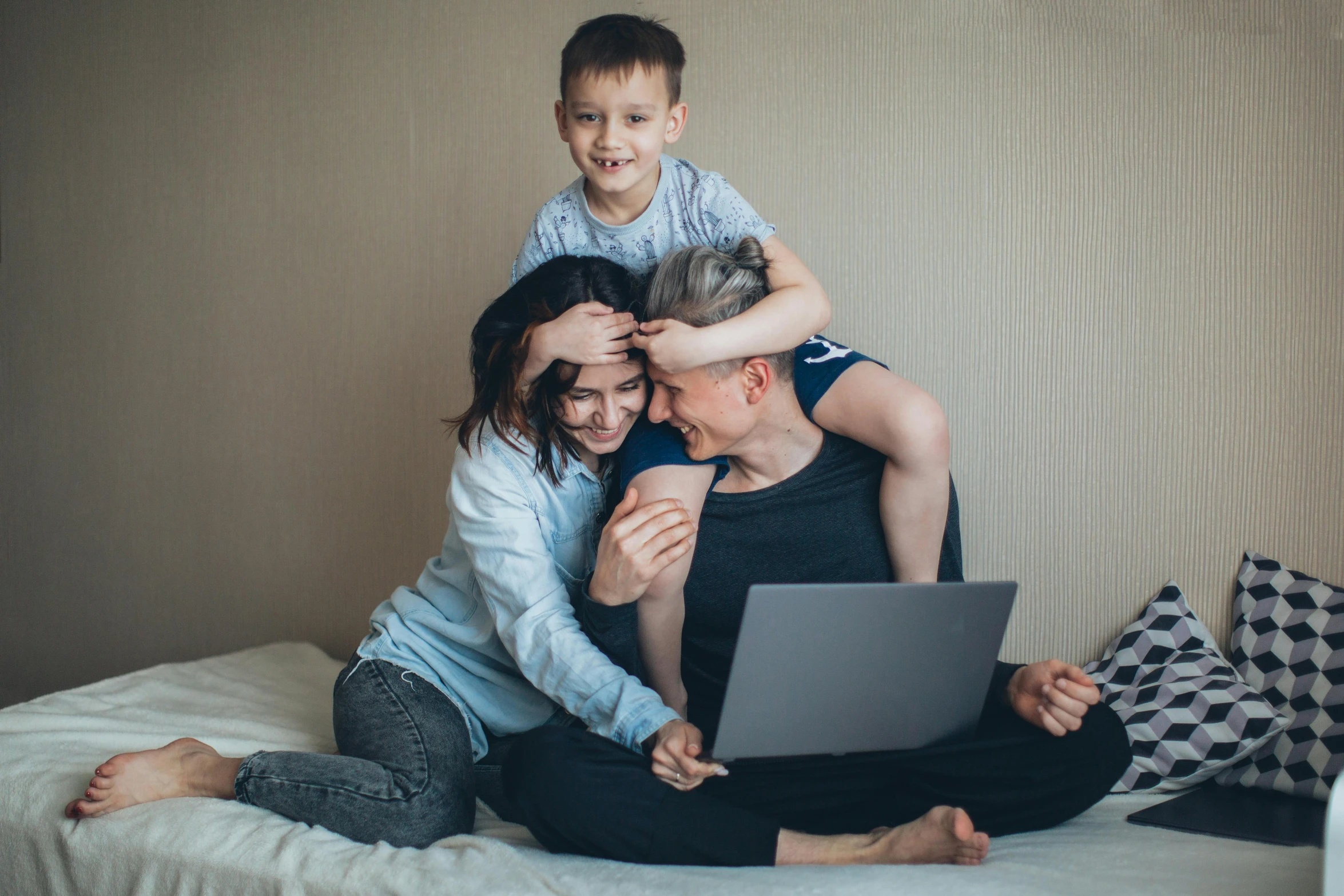 a woman sitting on a bed with a child on her lap, a picture, pexels, figuration libre, portrait of family of three, sitting at a computer, everyone having fun, avatar image