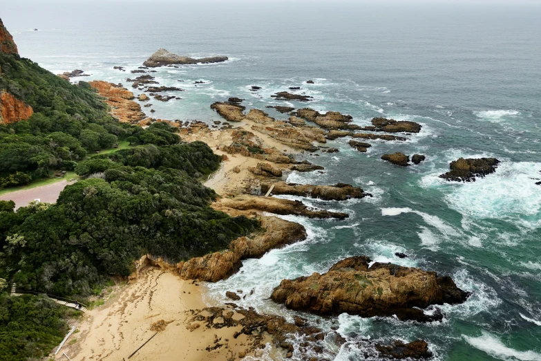 a view of the ocean from the top of a hill, a photo, rock pools, helicopter view, chiseled formations, birds eye photograph