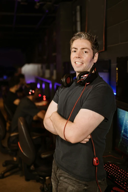 a man standing in front of a computer desk, a portrait, featured on reddit, esports, very slightly smiling, server in the middle, arms folded