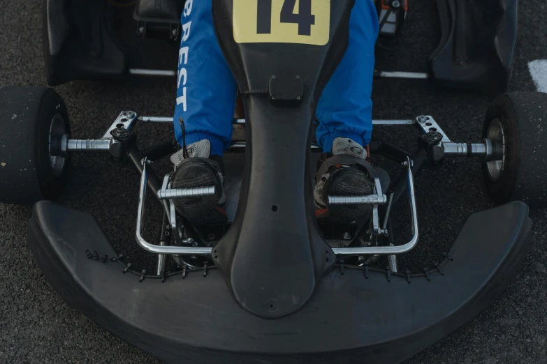 a close up of a person riding a go kart, full view of a car, vehicle