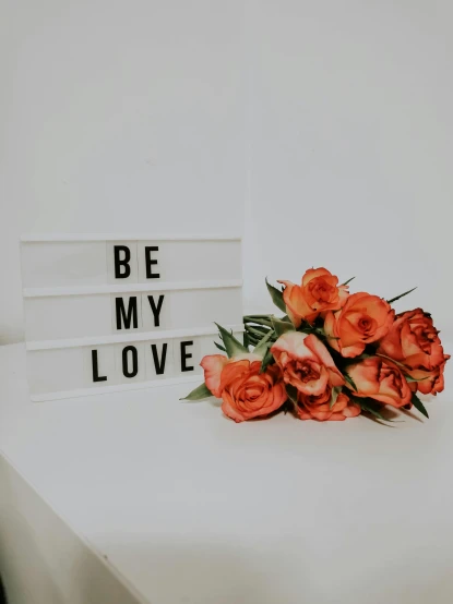 a bouquet of flowers sitting on top of a white table, by Robbie Trevino, pexels contest winner, bright signage, love theme, be real, 1 as february)