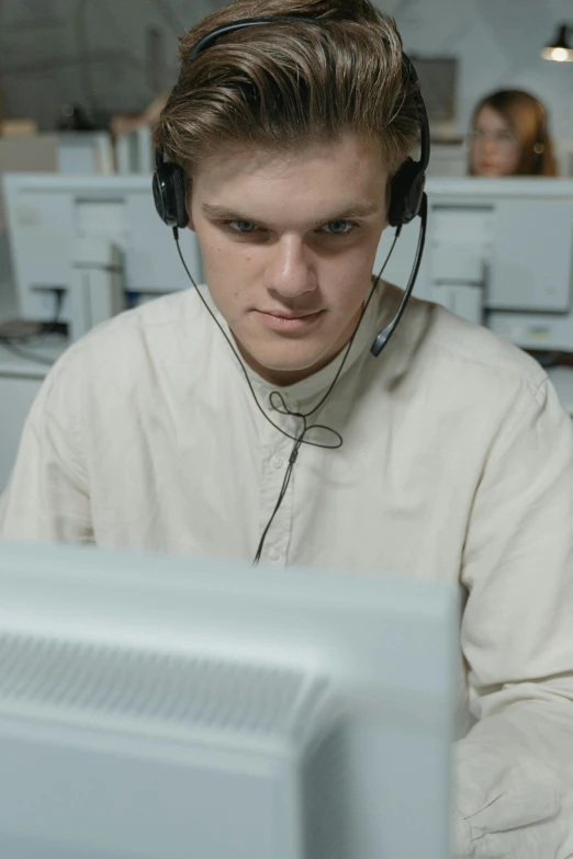 a man wearing headphones sitting in front of a computer, a colorized photo, reddit, russian academic, staring at you, maintenance, server in the middle