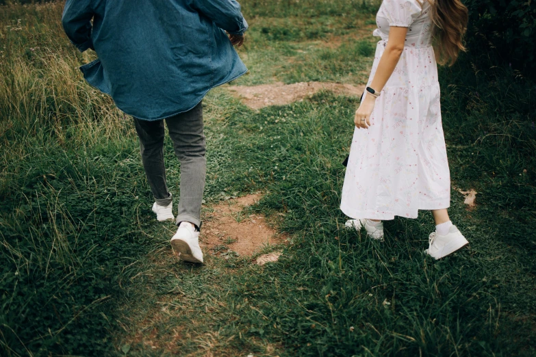 a couple of people that are walking in the grass, pexels contest winner, happening, conservatively dressed, long distance, girls, about to step on you