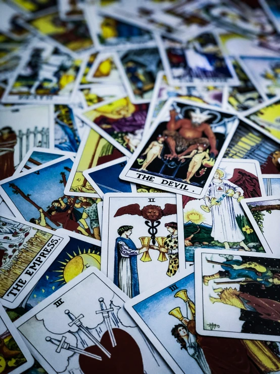 a pile of tarot cards sitting on top of a table, half image, ilustration, government archive photograph, zodiac signs