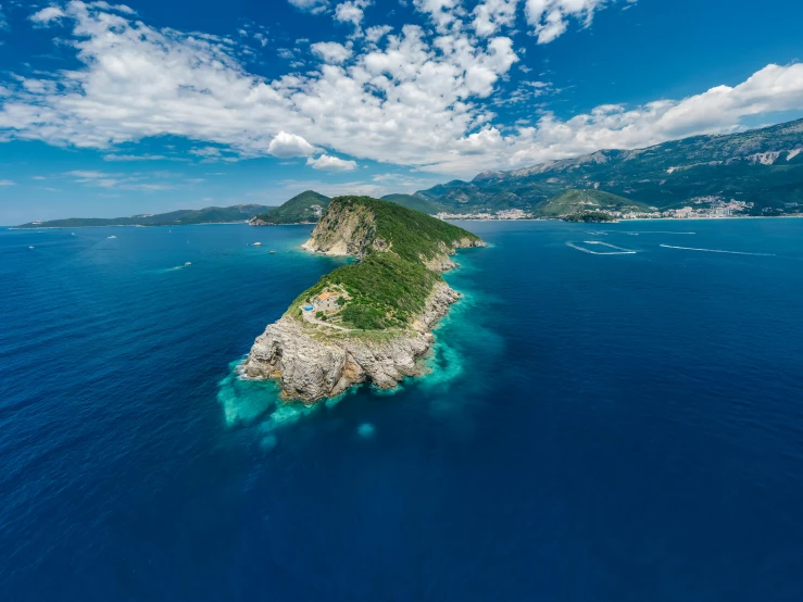 a small island in the middle of the ocean, by Daren Bader, pexels contest winner, renaissance, croatian coastline, “ aerial view of a mountain, slim aarons, blue sky