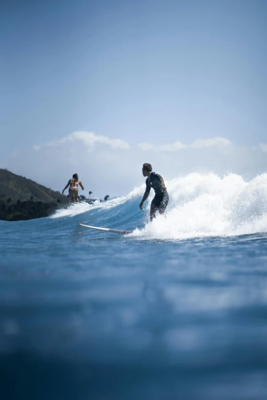 a man riding a wave on top of a surfboard, black sand, male and female, reefs, slide show
