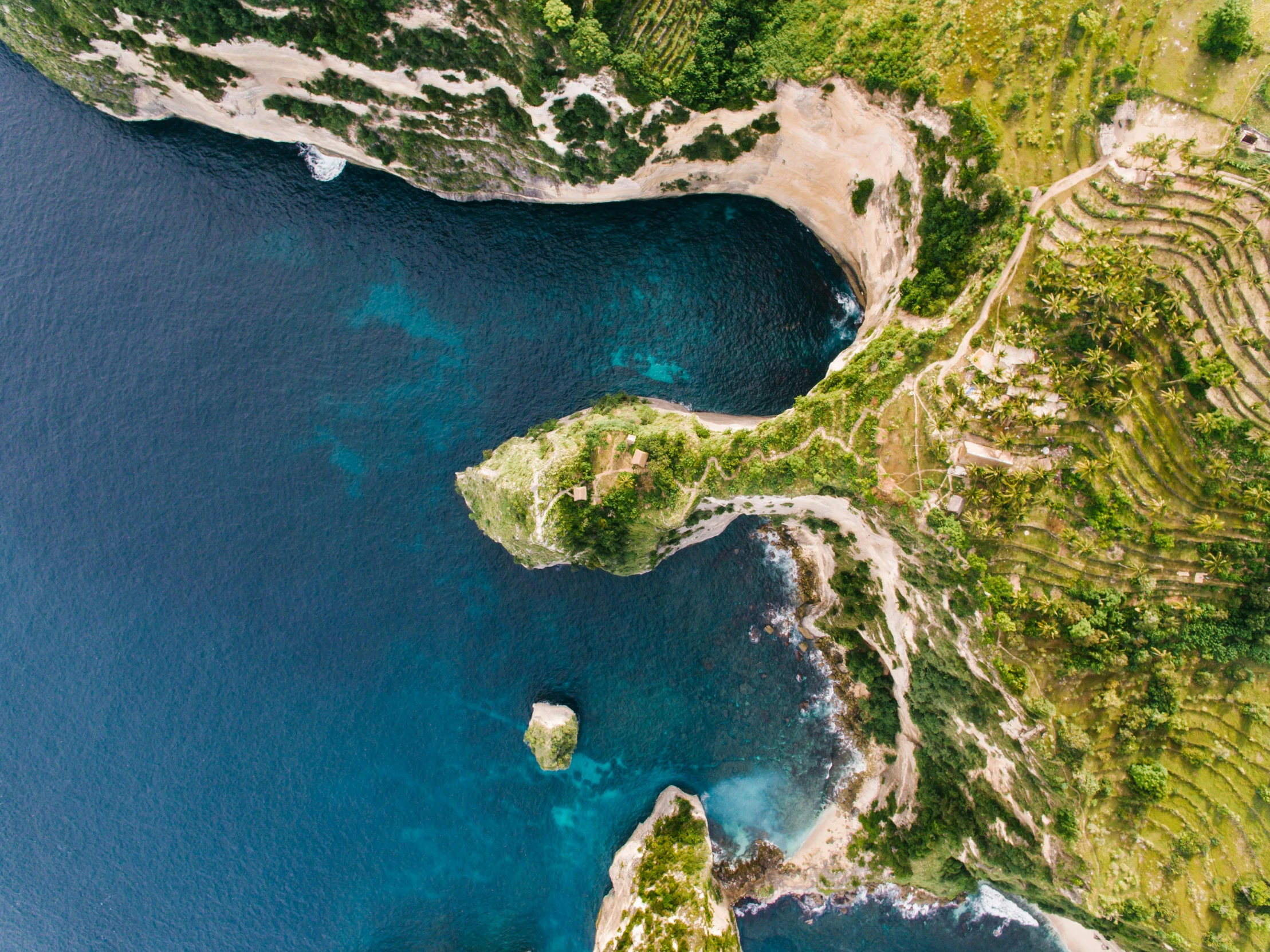 a large body of water next to a lush green hillside, pexels contest winner, renaissance, calanque, drone photograpghy, ignant, scylla and charybdis