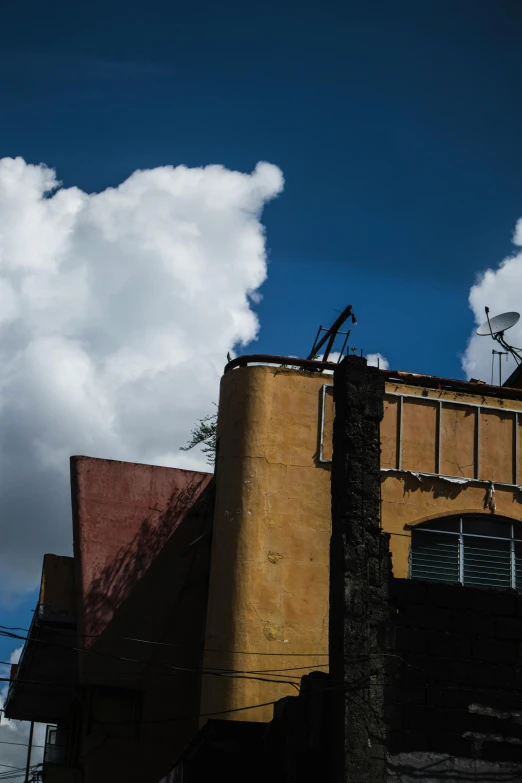 a man flying through the air while riding a snowboard, a photo, unsplash, modernism, “derelict architecture buildings, tall fluffy clouds, downtown mexico, leica s photograph