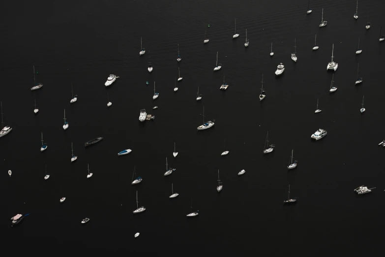 a group of boats floating on top of a body of water, inspired by Andreas Gursky, pexels contest winner, dark dingy, rhode island, ignant, sailboat