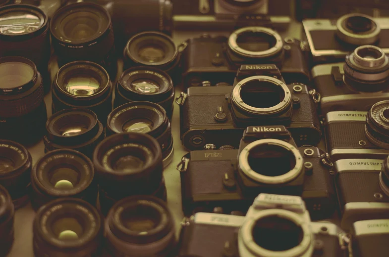 a bunch of cameras sitting on top of a table, a picture