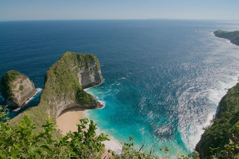 a large body of water sitting on top of a lush green hillside, pexels contest winner, happening, blue sand, avatar image, sharp cliffs, square