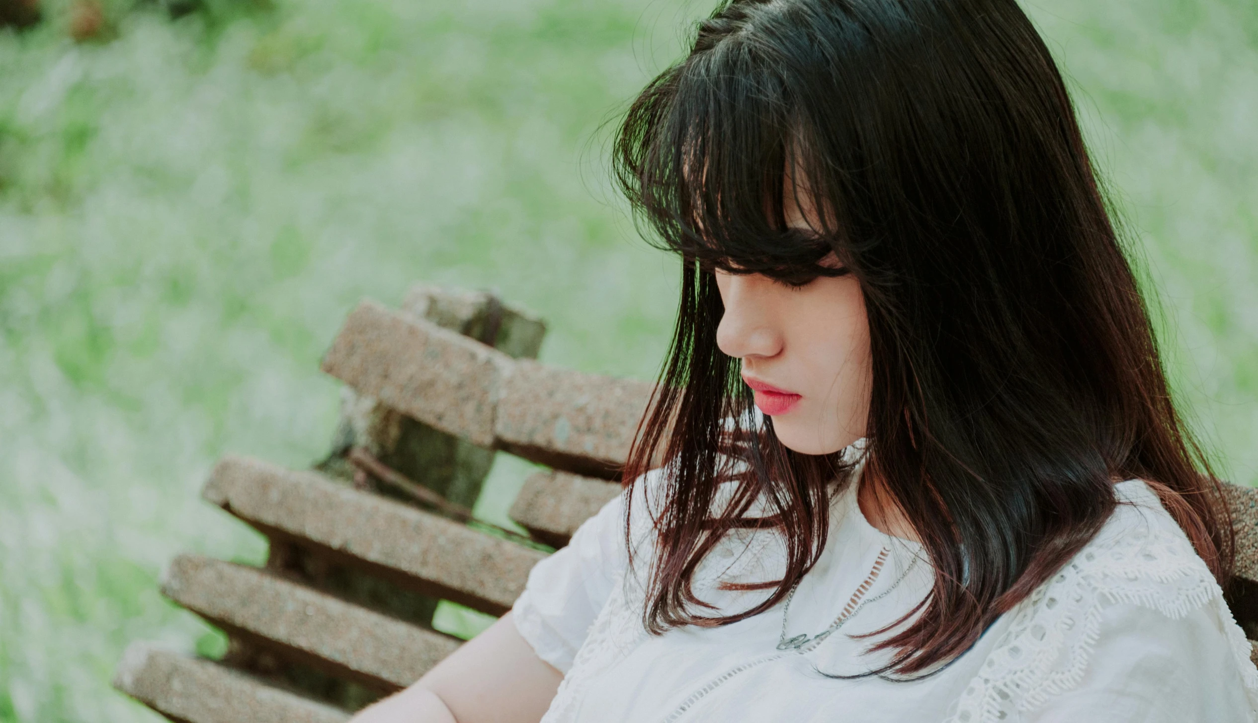 a woman sitting on top of a wooden bench, pexels contest winner, girl with black hair, pouty lips, : :, promo image