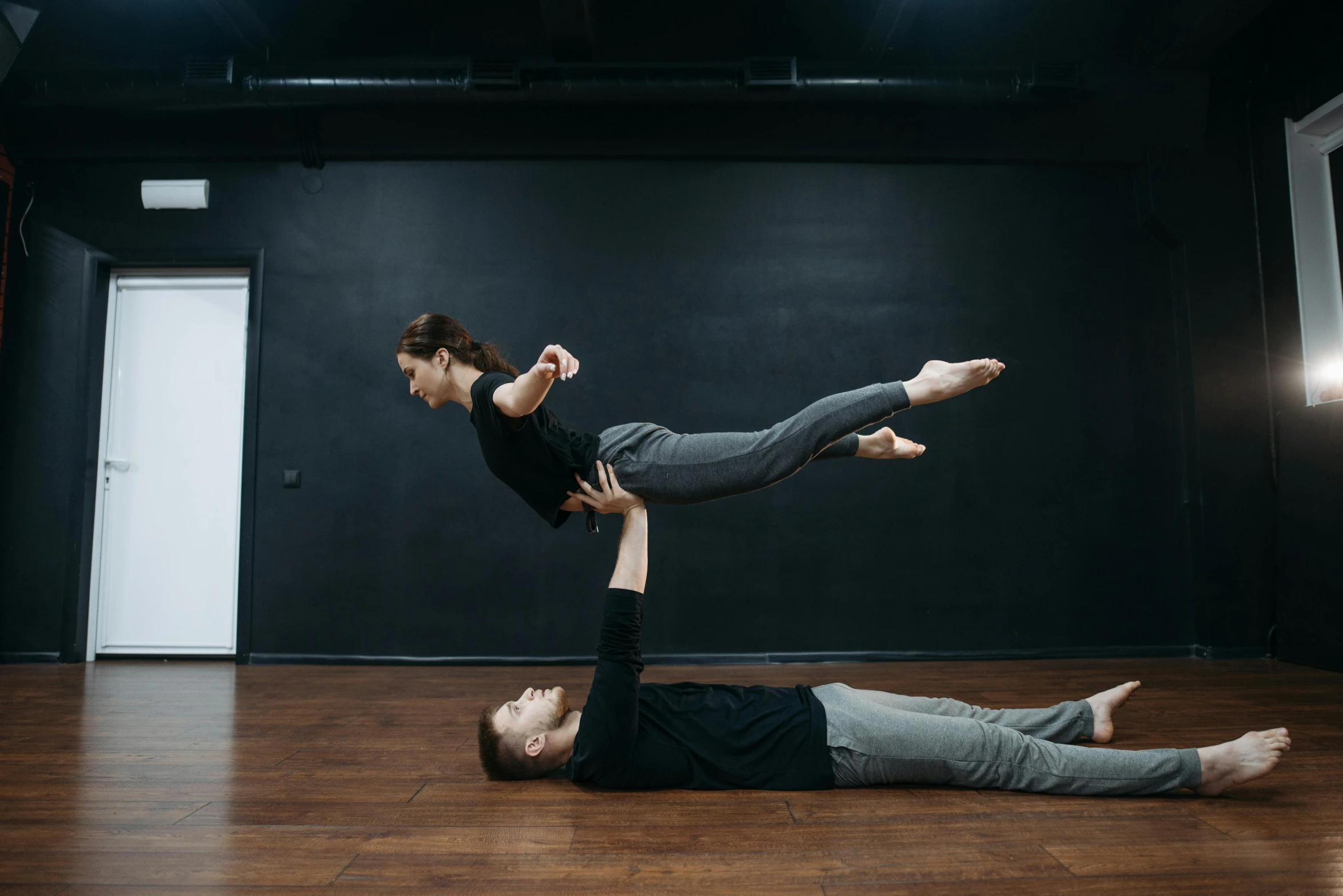 a man and woman doing a handstand in a dance studio, by Emma Andijewska, arabesque, sergey vasnev, floating on space, thumbnail, flattened