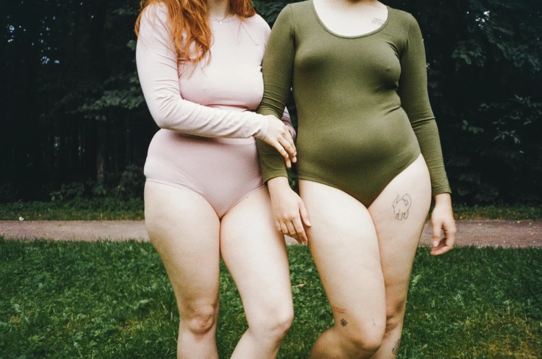 a couple of women standing next to each other, inspired by Elsa Bleda, pexels contest winner, renaissance, kaki body suit, green and pink, thicc, pale skin