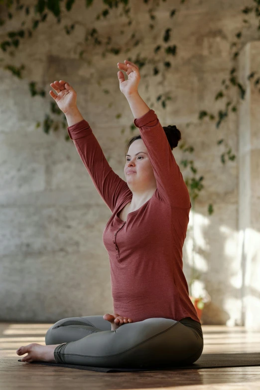 a woman sitting on the floor in a yoga pose, renaissance, with arms up, plus-sized, grey, maroon