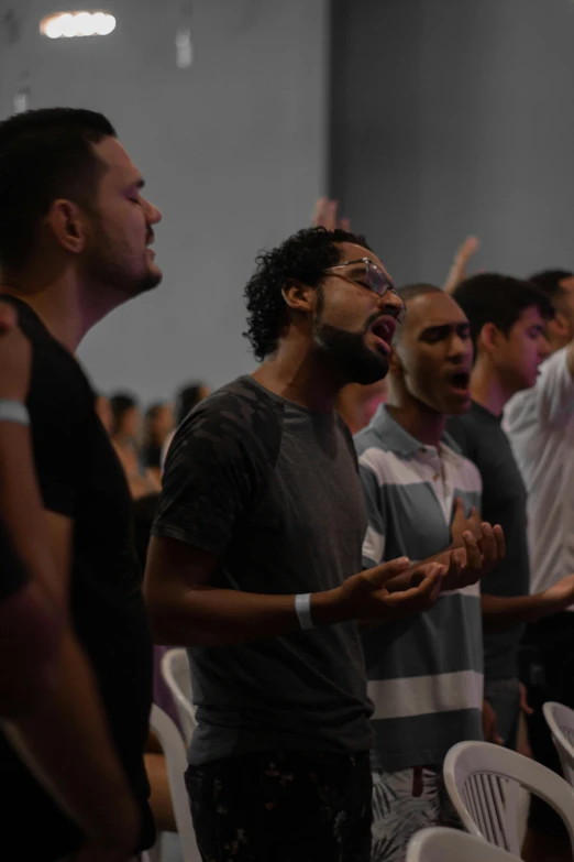 a group of men standing next to each other in a room, trending on unsplash, happening, many people worshipping, brazil, singing, square