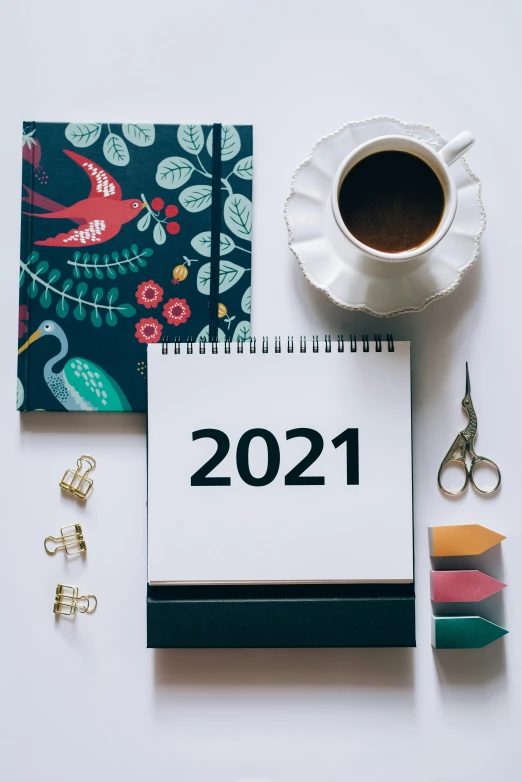 a notepad sitting on top of a desk next to a cup of coffee, a picture, trending on pexels, happening, new years eve, from star trek 2021, thumbnail, diecut