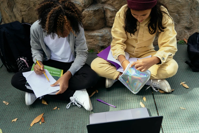 a couple of girls sitting next to each other on the ground, trending on pexels, computer art, whiteboards, school courtyard, thumbnail, high angle close up shot