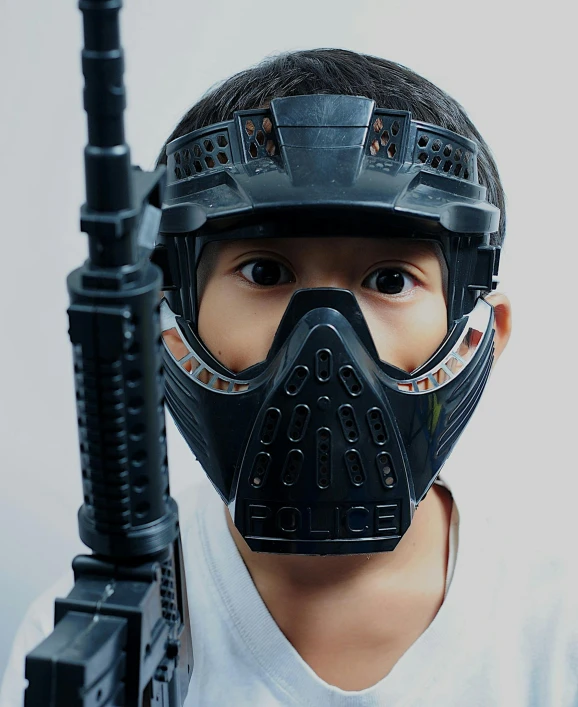 a young boy wearing a gas mask and holding a gun, pexels contest winner, dystopian toy, swat helmet, bio - mech face, instagram story