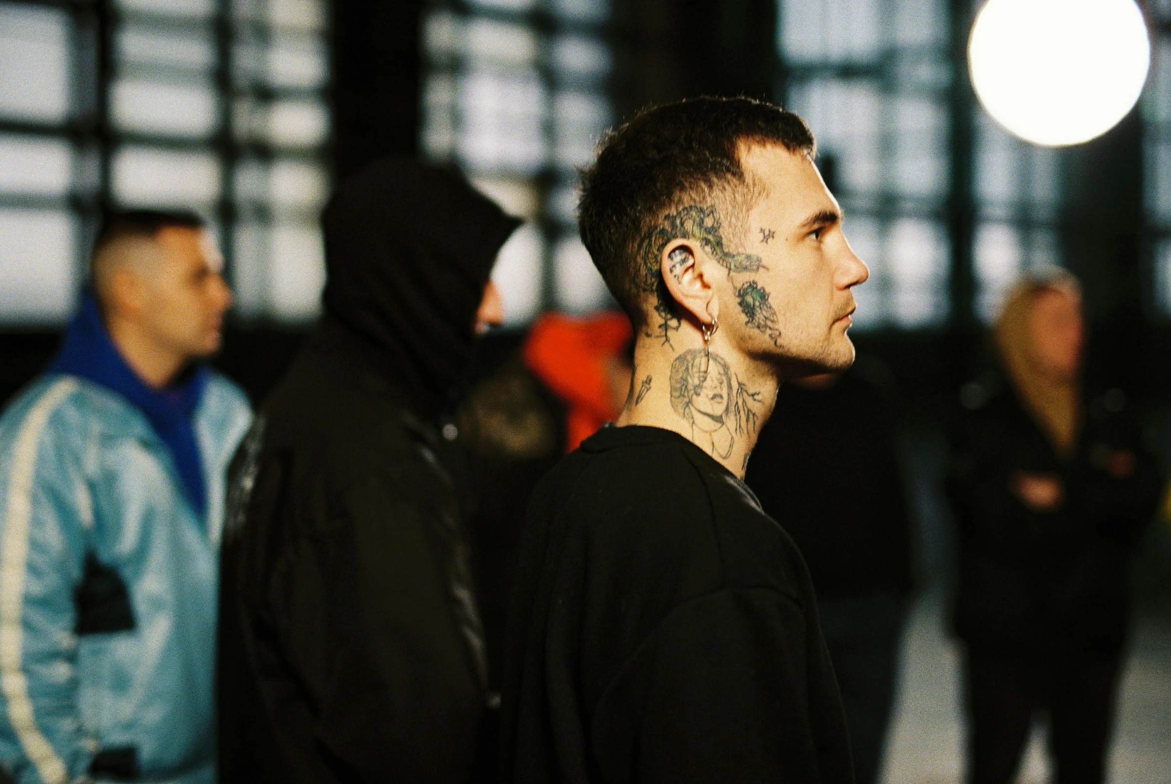 a group of men standing next to each other, a tattoo, trending on pexels, hyperrealism, gauged ears, with prison clothing, profile image, autechre