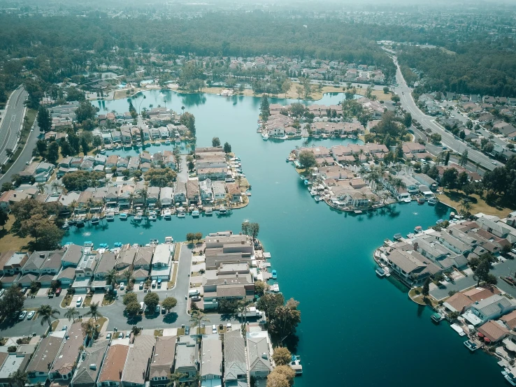 a large body of water surrounded by lots of houses, by Ryan Pancoast, pexels contest winner, central california, canals, 80s photo, crystal lake