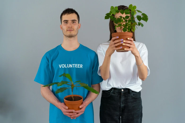 a man standing next to a woman holding a potted plant, pexels contest winner, tshirt, humanity, without duplicate image, profile image