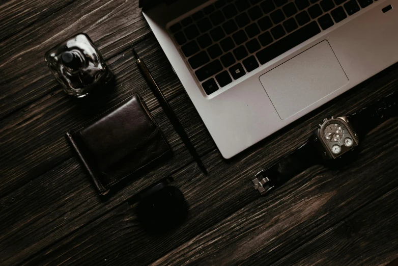 a laptop computer sitting on top of a wooden table, by Romain brook, trending on pexels, black and brown, knolling, late night, brown