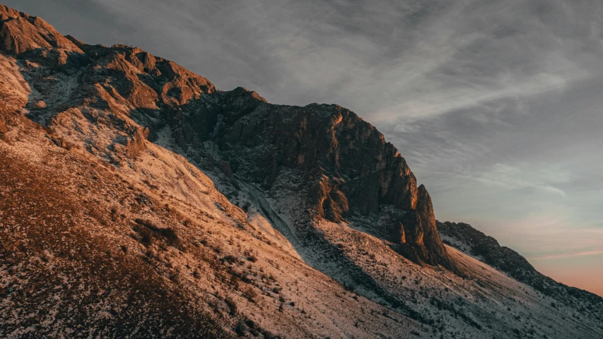 a mountain covered in snow under a cloudy sky, inspired by Filip Hodas, unsplash contest winner, australian tonalism, golden hour hues, extremely detailed rocky crag, instagram picture, instagram photo