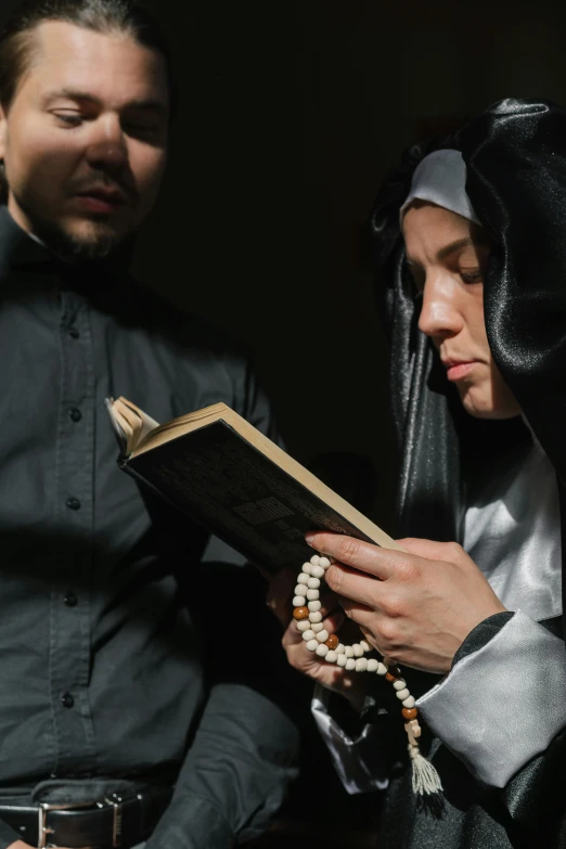 a man and a woman reading a book, nun outfit, 2019 trending photo, 256435456k film, multiple stories