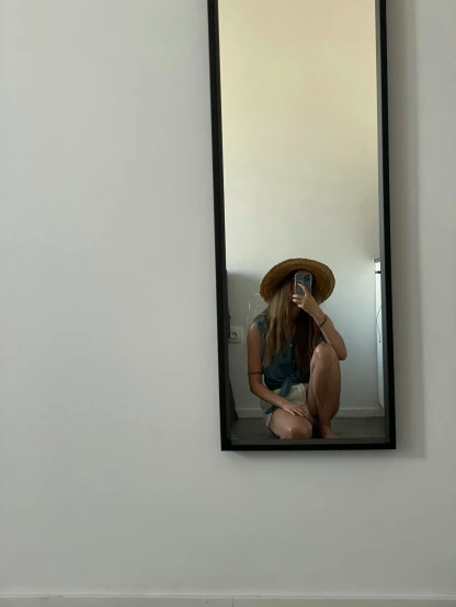 a woman taking a picture of herself in a mirror, by Maggie Hamilton, low quality photo, straw hat, minimalistic!! simple, fullbody photo