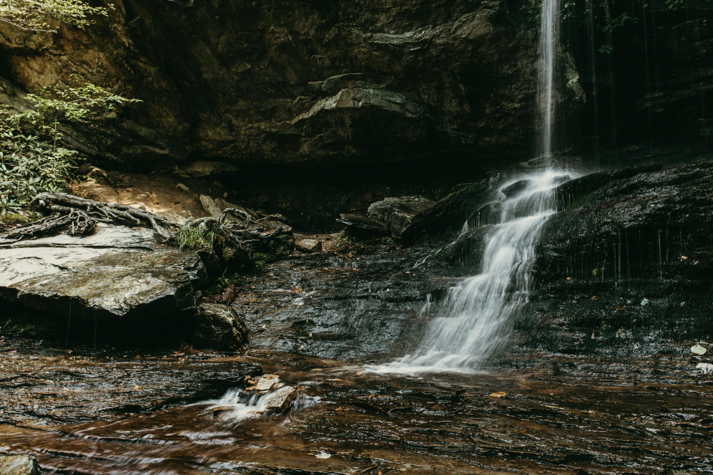 a waterfall in the middle of a forest, by Daniel Seghers, unsplash contest winner, australian tonalism, deep clear pools of water, rocky cliff, unsplash 4k, low - angle shot