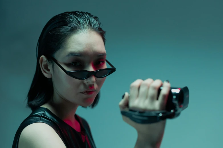 a close up of a person holding a cell phone, cyberpunk art, inspired by Yanjun Cheng, unsplash, neo-figurative, 2 techwear women, li bingbing, action poses with weapons, vr sunglasses