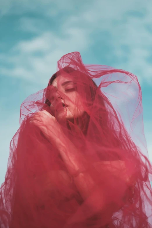 a woman with a red veil covering her face, an album cover, inspired by Ren Hang, pexels contest winner, made of cotton candy, florence pugh, !!! colored photography, the sky is red