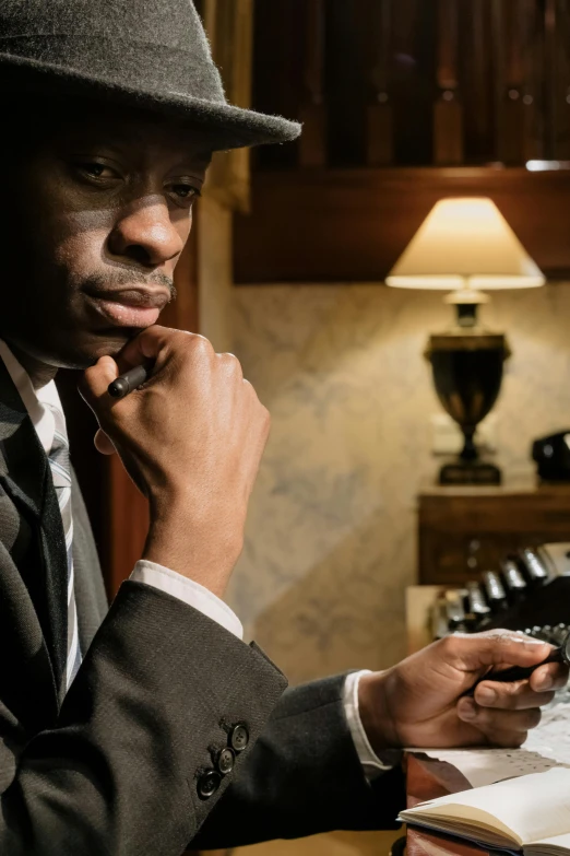 a man sitting at a table with a cell phone in his hand, an album cover, inspired by Yousuf Karsh, unsplash, harlem renaissance, 1 9 2 0's style speakeasy, movie scene close up, telephone, ( ( theatrical ) )