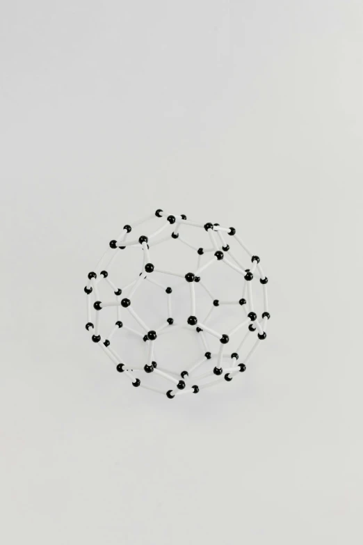 a close up of a circular object on a white surface, by Buckminster Fuller, classic 3 d model of molecule, courtesy of centre pompidou, ffffound, ebony