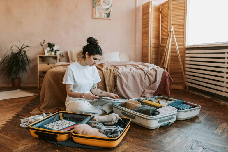 a woman sitting on the floor with her luggage, by Julia Pishtar, pexels contest winner, happening, sitting on her bed, inspect in inventory image, australian, 🦩🪐🐞👩🏻🦳