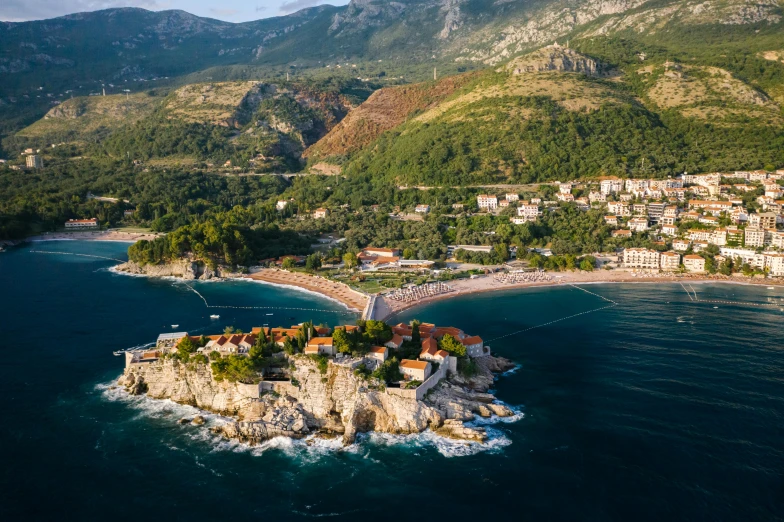 a small island in the middle of the ocean, by Emma Andijewska, pexels contest winner, renaissance, white buildings with red roofs, boka, “ aerial view of a mountain, festivals