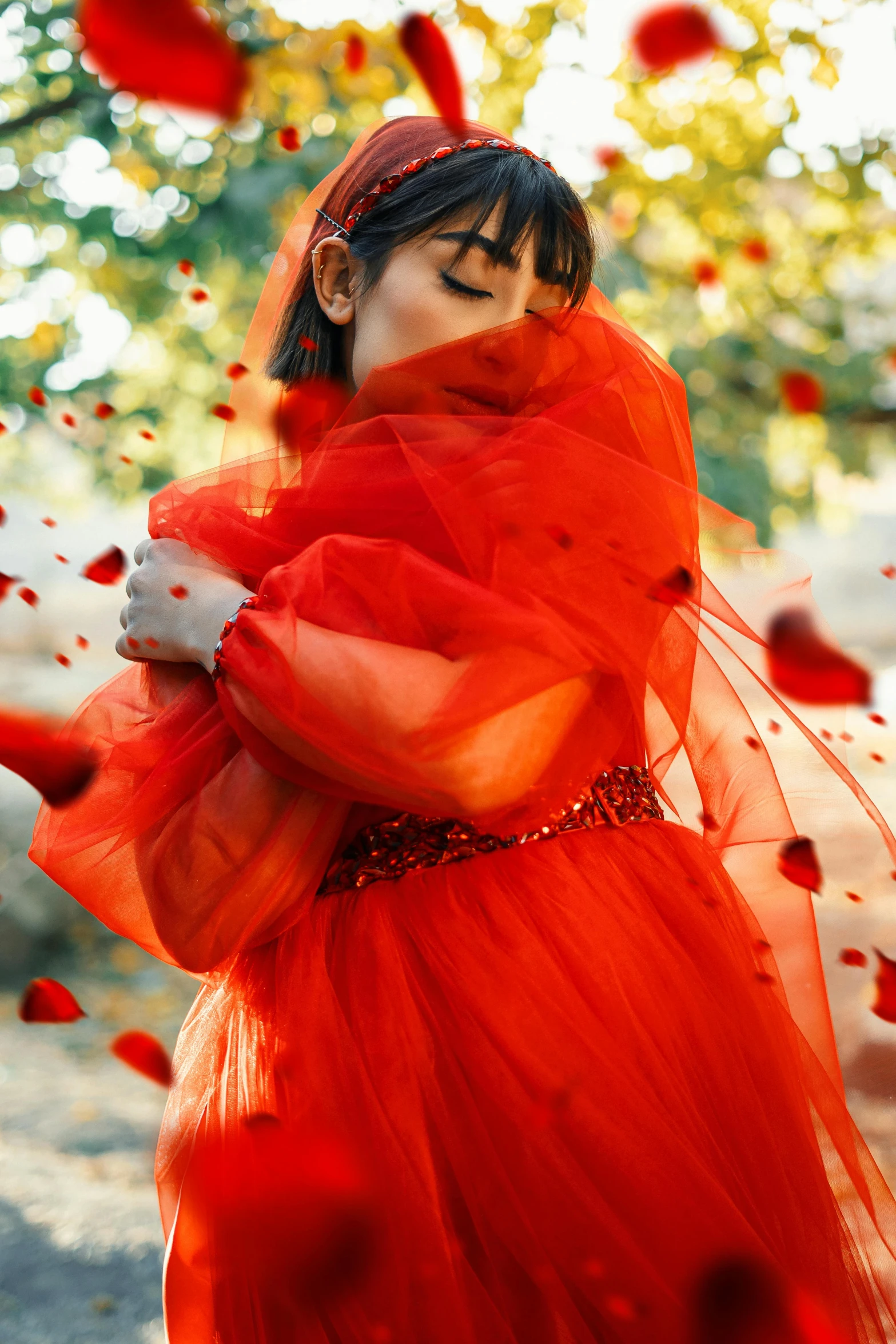 a woman in a red dress is surrounded by petals, by Julia Pishtar, wearing organza gown, falling in love, red scarf, lulu chen