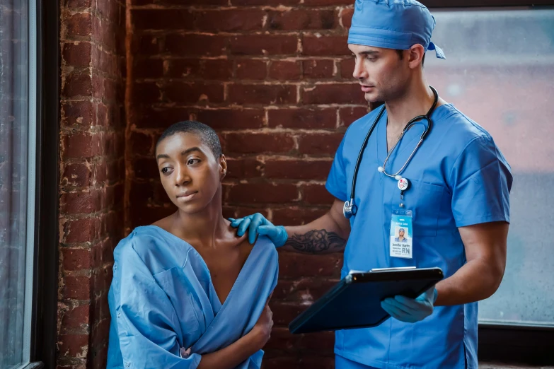 a man standing next to a woman in scrubs, pexels contest winner, renaissance, ashteroth, complex scene, male physician, ots shot