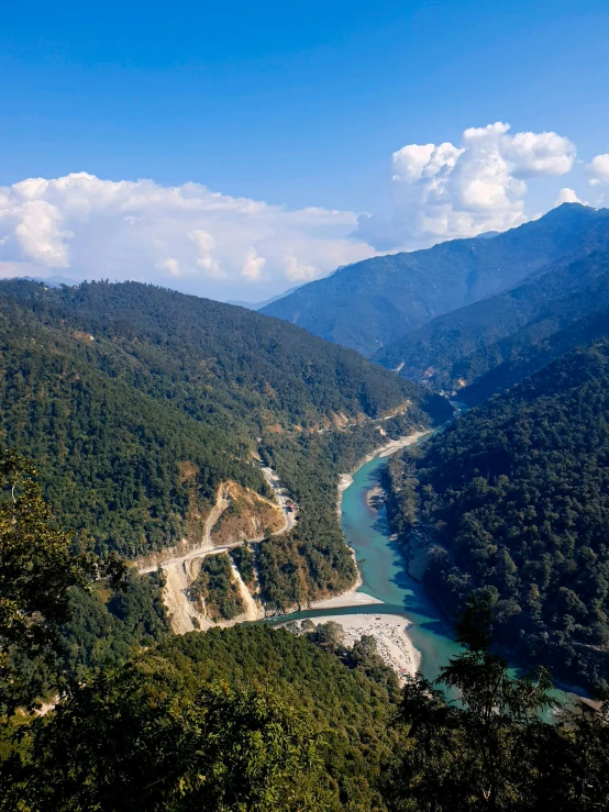 a river flowing through a lush green valley, landslides, profile image, thumbnail, day light