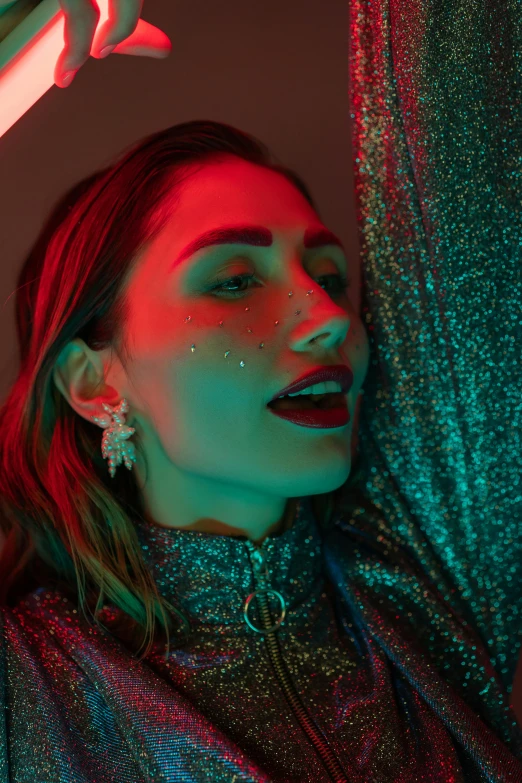 a woman holding a pair of scissors over her head, an album cover, inspired by Elsa Bleda, trending on pexels, holography, gal gadot portrait, glitter gif, red neon roses, earrings