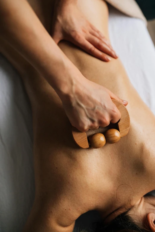 a woman getting a back massage at a spa, by Juan O'Gorman, eucalyptus, oak, tamborine, back arched