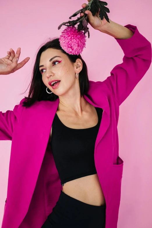 a woman with a pink flower in her hair, trending on pexels, antipodeans, wearing disco suit, playful pose of a dancer, wearing jacket, product introduction photo