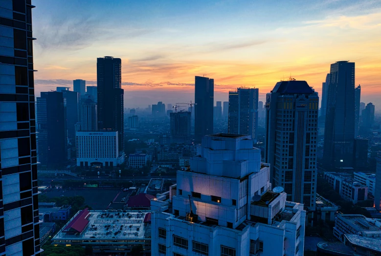 a view of a city from a high rise building, by Erik Pevernagie, pexels contest winner, happening, south jakarta, 8k hdr sunset lit, subtitles, minimalist
