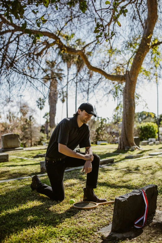 a man kneeling in the grass with a guitar case, graveside, wearing nike air mags, wearing plumber uniform, profile image